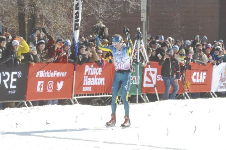 Woman winner crosses finish.jpg